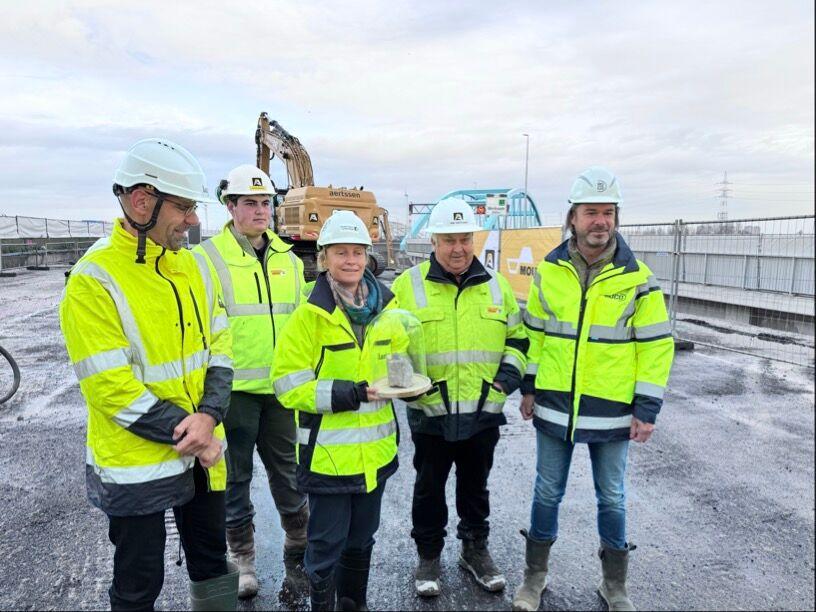 Flemish Minister Annick De Ridder operates a crane to symbolically start the Merksem viaduct demolition works
